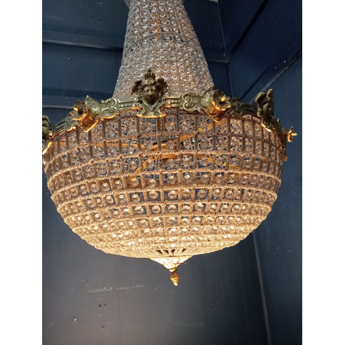 498 - A CONTINENTAL GILT BRASS AND CUT GLASS BASKET CENTRE LIGHT with cascading pendant drops the circlet ... 