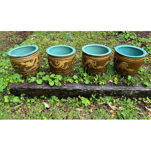 701 - A SET OF FOUR GLAZED TERRACOTTA PLANTERS each of cylindrical tapering form the turquoise and brown g... 