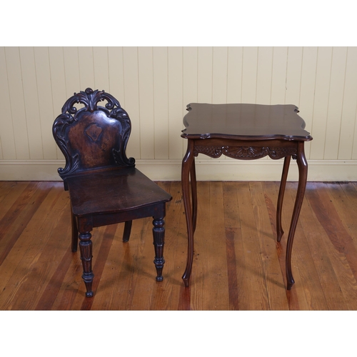 15 - A 19TH CENTURY CARVED MAHOGANY HALL CHAIR, A VINTAGE MAHOGANY OCCASIONAL TABLE of serpentine outline... 