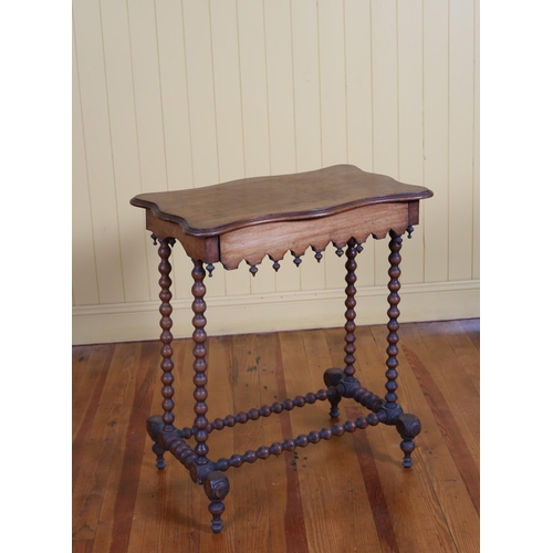 16 - A 19TH CENTURY MAHOGANY OCCASIONAL TABLE of serpentine outline on bobbin turned supports joined by c... 