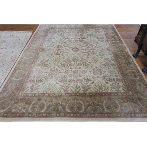 175 - A WOOL RUG the beige ground with central floral panel filled with flowerheads and foliage within a c... 