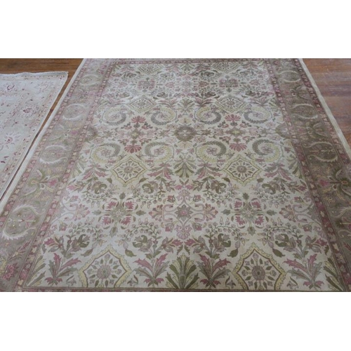 175 - A WOOL RUG the beige ground with central floral panel filled with flowerheads and foliage within a c... 