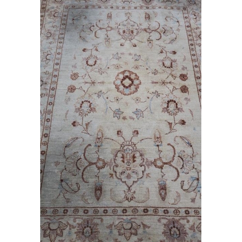 176 - A WOOL RUG the beige ground with central floral panel within a conforming border 235cm (l) x 169cm (... 