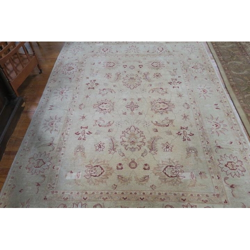 177 - A WOOL RUG the beige ground with central panel filled with flowerheads and foliage within a conformi... 