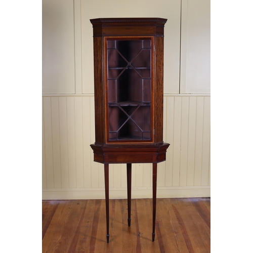 18 - AN EDWARDIAN MAHOGANY AND SATINWOOD INLAID CORNER CABINET with astragal glazed door above a moulded ... 