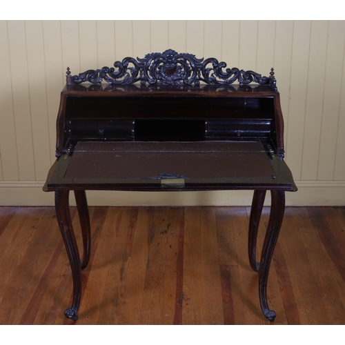 191 - A 19TH CENTURY CONTINENTAL CARVED ROSEWOOD SLOPE FRONT BUREAU the pierced carved gallery above a hin... 