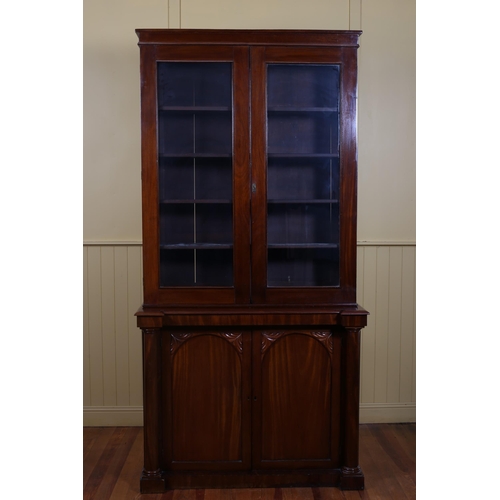 193 - A 19TH CENTURY MAHOGANY TWO DOOR LIBRARY BOOKCASE the moulded cornice above a pair of glazed doors c... 