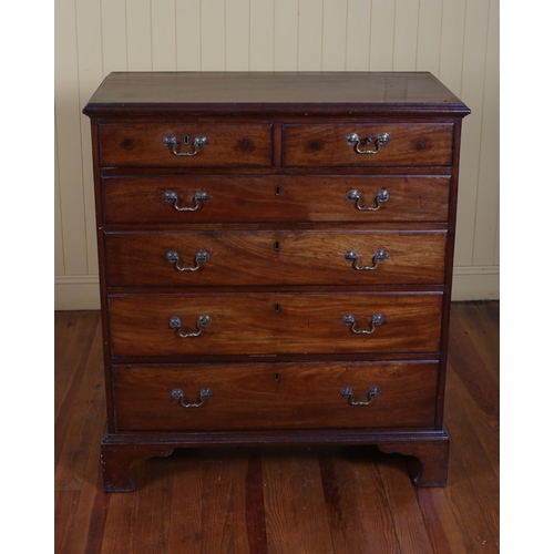 195 - A GEORGIAN MAHOGANY CHEST of two short and four long graduated drawers with brass drop handles and b... 