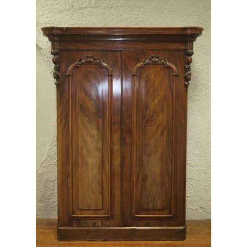 20 - A VICTORIAN CARVED MAHOGANY TWO DOOR WARDROBE on platform support 215cm (h) x 160cm (w) x 65cm (d)