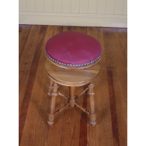 210 - A STAINED WOOD AND UPHOLSTERED ADJUSTABLE STOOL the buttoned upholstered seat with brass studs on ba... 