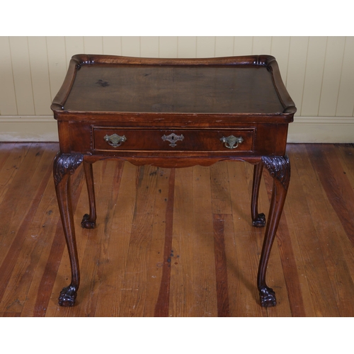 212 - A VINTAGE WALNUT OCCASIONAL TABLE the rectangular dished top above a frieze drawer on cabriole legs ... 