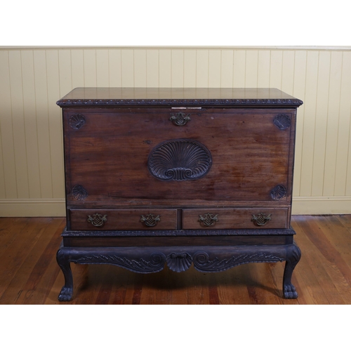 22 - AN IRISH GEORGIAN MAHOGANY FALL FRONT CABINET with shell carving above two short drawers on carved b... 