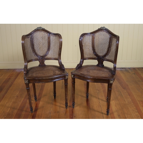 3 - A PAIR OF CONTINENTAL STAINED WOOD GILT BRASS MOUNTED AND CANED CHAIRS each with a shaped back and s... 