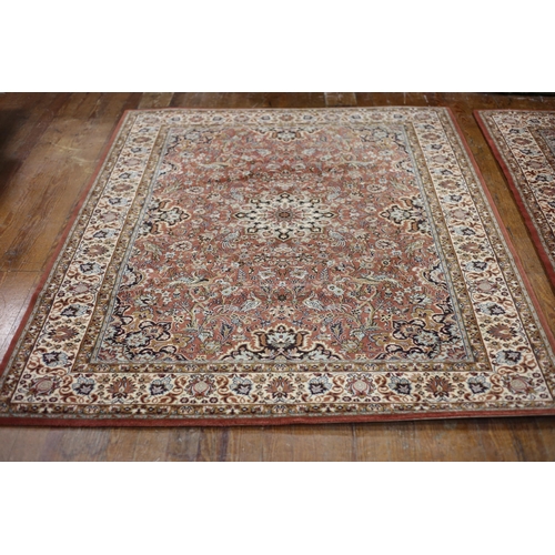 385 - A MULTICOLOURED GROUND PATTERN RUG the central panel filled with flowerheads and foliage within a co... 