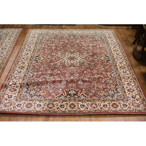 386 - A MULTICOLOURED GROUND PATTERN RUG the central panel filled with flowerheads and foliage within a co... 