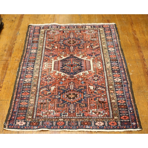 387 - A WOOL RUG the light pink and light blue ground with central panel filled with serrated panels and h... 