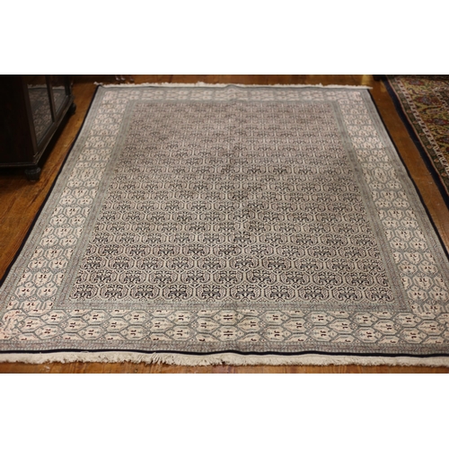 388 - AN ORIENTAL SILK RUG the light blue and cream ground with central panel filled with stylised foliate... 