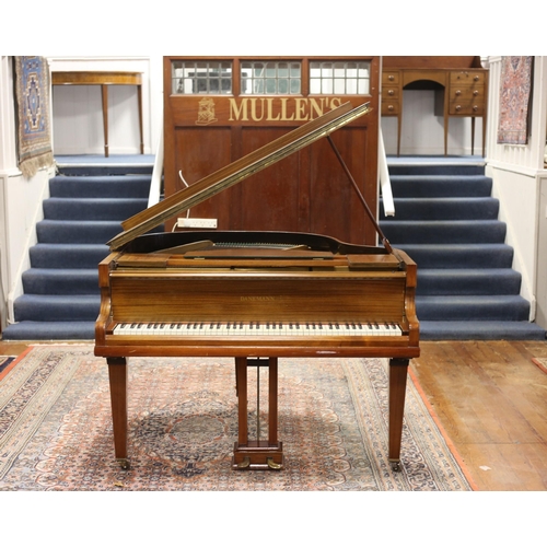 396 - A DANEMANN MAHOGANY CASED BABY GRAND PIANO raised on square tapering legs with brass caps and castor... 