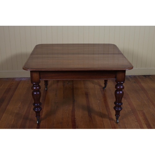 405 - A 19TH CENTURY MAHOGANY TELESCOPIC DINING TABLE with one loose leaf on baluster legs with brass caps... 