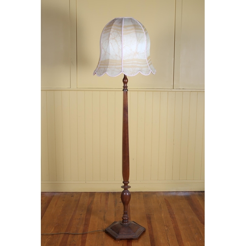 409 - A VINTAGE MAHOGANY STANDARD LAMP the octagonal shaped column above a spreading foot with shade 200cm... 