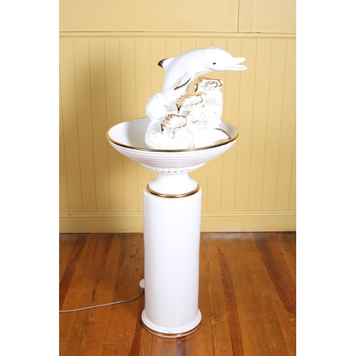 422 - BONDIA A continental white and gilt porcelain fountain surmounted by dolphins and shells above a dis... 