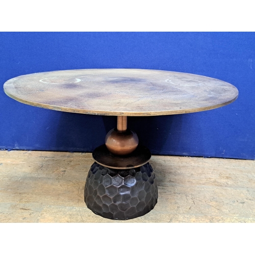 464 - A BRUSHED BRONZE COFFEE TABLE of circular outline raised on cylindrical and spherical column on a ho... 