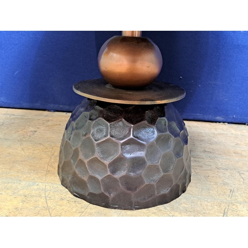 464 - A BRUSHED BRONZE COFFEE TABLE of circular outline raised on cylindrical and spherical column on a ho... 