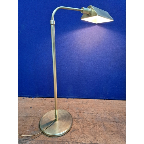 465 - A VINTAGE BRASS TELESCOPIC READING LAMP with adjustable shade above a circular foot 75cm (h) x 50cm ... 