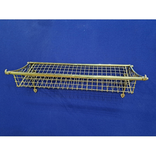 469 - A WALL MOUNTED BRASS CARRIAGE / LUGGAGE RACK with open work tray 25cm (h) x 76cm (w) x 30cm (d)