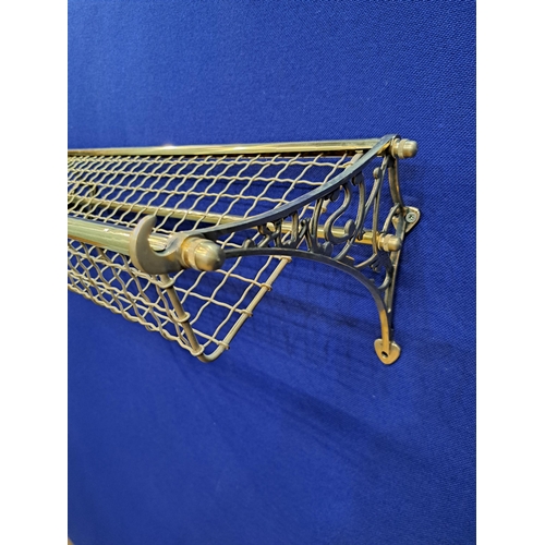 469 - A WALL MOUNTED BRASS CARRIAGE / LUGGAGE RACK with open work tray 25cm (h) x 76cm (w) x 30cm (d)