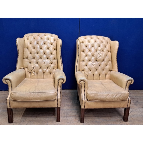 472 - A FINE PAIR OF GEORGIAN STYLE MAHOGANY AND HIDE UPHOLSTERED WING CHAIRS each with a deep buttoned up... 