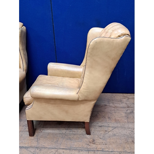 472 - A FINE PAIR OF GEORGIAN STYLE MAHOGANY AND HIDE UPHOLSTERED WING CHAIRS each with a deep buttoned up... 