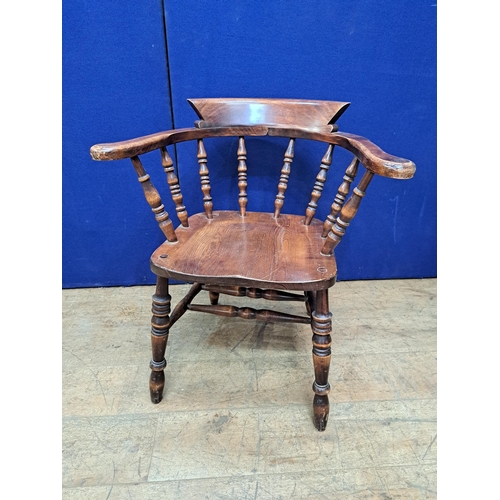 477 - A VINTAGE OAK SMOKER'S BOW CHAIR with baluster splats and panel seat on conforming legs 78cm (h) 69c... 