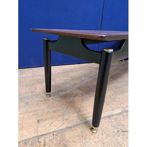 480 - A RETRO TEAK COFFEE TABLE of rectangular form on cylindrical tapering legs with brass pad feet 48cm ... 