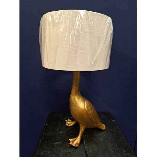 483 - A GILT TABLE LAMP in the form of a duck with shade 60cm (h) x 30cm (d)