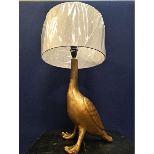 483 - A GILT TABLE LAMP in the form of a duck with shade 60cm (h) x 30cm (d)