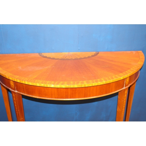 485 - A GEORGIAN STYLE MAHOGANY CROSSBANDED SIDE TABLE of demi lune outline raised with square tapering le... 