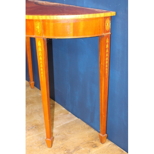 485 - A GEORGIAN STYLE MAHOGANY CROSSBANDED SIDE TABLE of demi lune outline raised with square tapering le... 