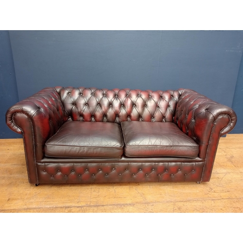 488 - A VICTORIAN STYLE HIDE UPHOLSTERED LIBRARY SETTEE with deep buttoned upholstered back and seat with ... 