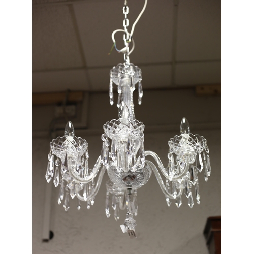 493 - A WATERFORD CUT GLASS SIX BRANCH CHANDELIER hung with faceted pendants (en suite to the following lo... 