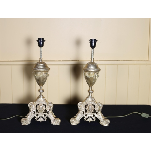 512 - A PAIR OF CONTINENTAL GILT BRASS TABLE LAMPS each of urn form raised on a pierced triform base with ... 