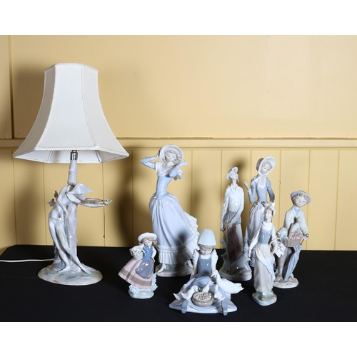 513 - EIGHT LLADRO FIGURES to include a figural table lamp with shade etc.