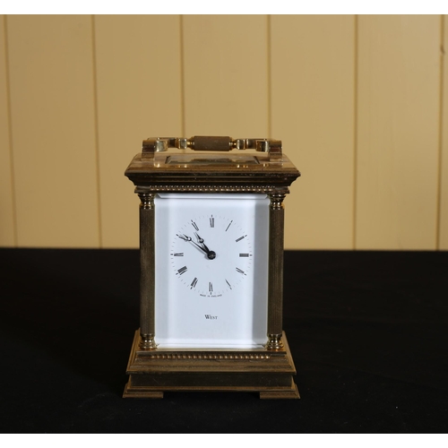 522 - A BRASS STRIKING CARRIAGE CLOCK the white enamel dial with Roman numerals inscribed 'West' 18cm (h) ... 