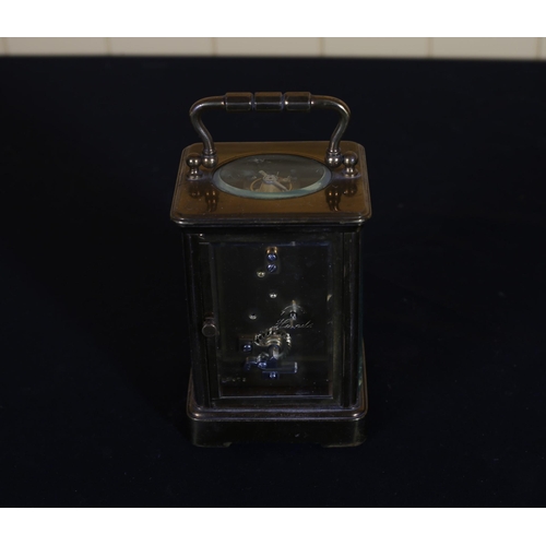 523 - A VINTAGE BRASS CARRIAGE CLOCK with enamel dial and Roman numerals 16cm (h) x 9cm (w) x 7cm (d)