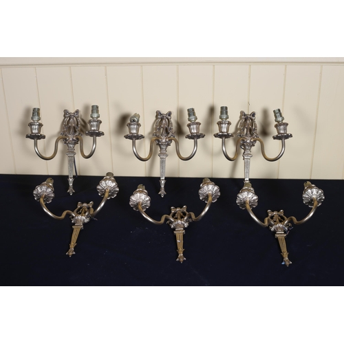 536 - A SET OF SIX BRASS TWO BRANCH CANDLE SCONCES each with a ribbon tied and laurel wreath backplate 21c... 