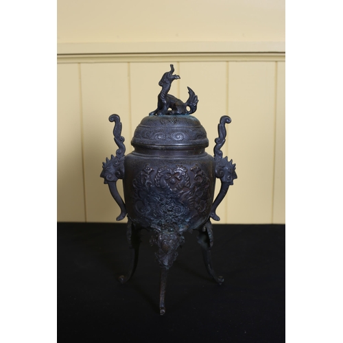 539 - A VINTAGE BURMESE BRASS LIDDED URN moulded in relief with stylised flowerheads and foliage on scroll... 