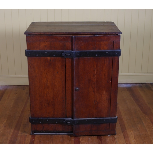 54 - A GEORGIAN OAK AND STEEL BOUND SPECIMEN CABINET the hinged door containing eight long graduated draw... 