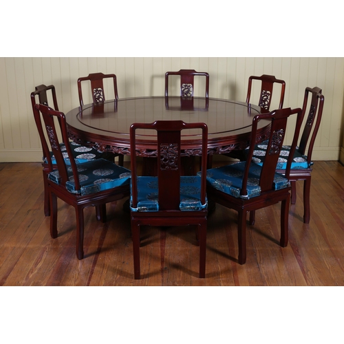 56 - A CHINESE ROSEWOOD TWELVE PIECE DINING ROOM SUITE comprising TEN CHAIRS each with a pierced vertical... 