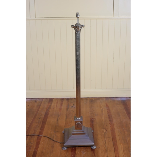 562 - A BRASS CORINTHIAN COLUMN STANDARD LAMP the reeded column above a square stepped base on pad feet 19... 