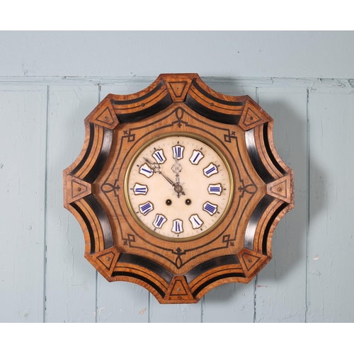 602 - A 19TH CENTURY WALNUT AND EBONISED WALL CLOCK the shaped case containing a white marble dial with en... 